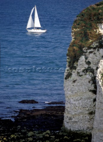 Cruising UK  yacht sails past Old Harry Rocks Poole Harbour