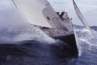 Bow of racing yacht crashing through a wave