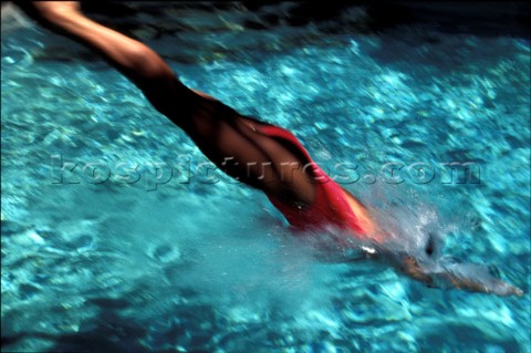 Woman diving into clear water