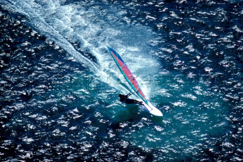 Aerial view of windsurfer speeding through the water