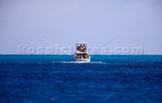 Game fishing boat with out riggers down
