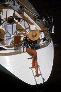 Woman in straw hat on stern of Swan 46