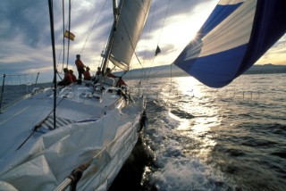 Sunset from onboard a racing yacht under spinnaker