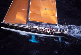 Bowman on the deck of Maxi yacht Unfurled in rough seas