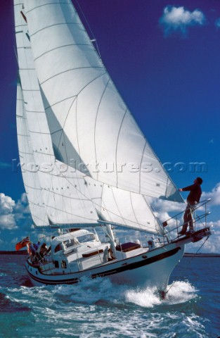 UK Cruising  Bowman on bow of yacht under full sail  Bowman on bow of yacht under full sail