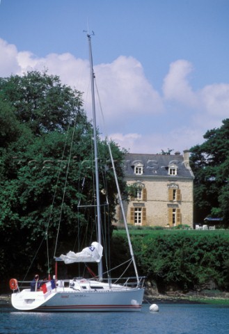 Sunsail  Brittany Coast Cruising European  Cruising yacht moored to a buoy by an old farmhouse on th