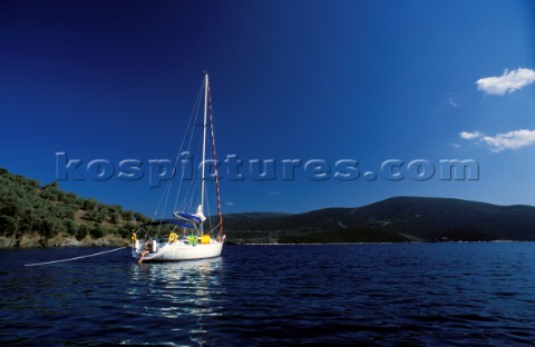Cruising yacht moored in a secluded bay Greece
