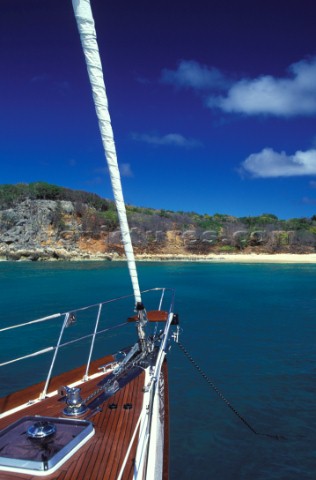 Foredeck of sailing yacht anchored off sandy beach  St Martin Caribbean