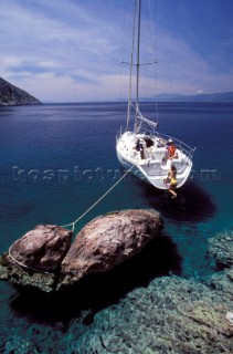 Crusing yacht with stern moored to rock, Greece