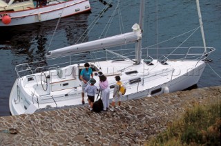 Family arrive to board a charter yacht for a holiday