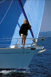 Girl on bow of cruising yacht