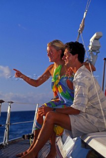Couple on board - cruising Romantic couple sailing aboard a cruising yacht
