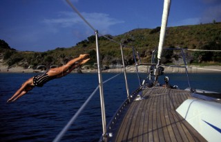 Woman diving off a Swan yacht in the Caribbean