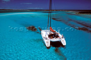 Catamaran anchored in clear blue water - Alans Key, Bahamas.