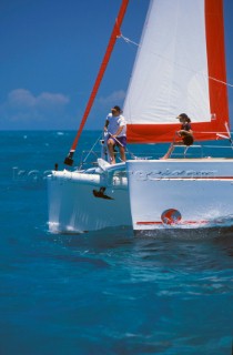 Father and daughter on bow of catamaran - Alans Key, Bahamas.