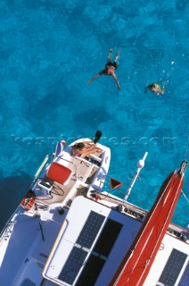 Swimming off the stern of a catamaran - Alans Key anchorage, Bahamas