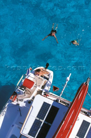 Swimming off the stern of a catamaran  Alans Key anchorage Bahamas