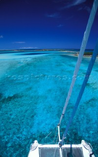 Bow of catamaran in shallow waters of Alan Keys Anchorage, Bahamas