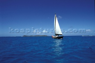 Cruising yacht sailing off Necker Island