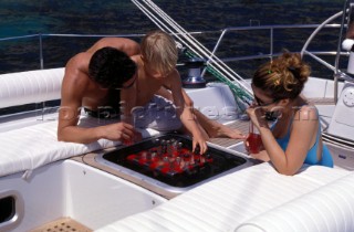 Family couple relax with the child on a cruising charter yacht