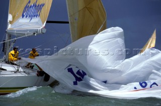 Crew on board racing yacht Hexe pull in the spinnaker