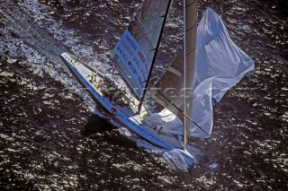 Teamwork onboard IACC Nippon Americas Cup yacht as the crew drop the spinnaker