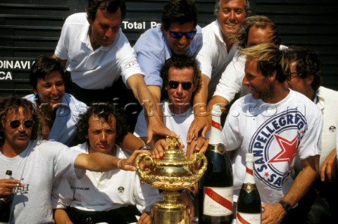 Winning crew of the 1995 Admirals Cup placing their hands on the trophy