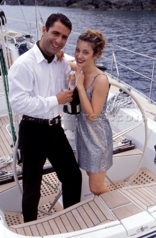 Couple with Champagne on Deck Lifestyle  Charter 99 Romantic couple celebrate a birthday onboard a y