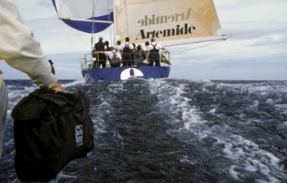 Cameraman filming yacht racing from a camera boat.