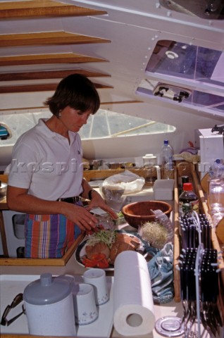Cook prepares food onboard a sailing yacht