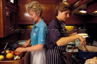 Cook prepares food below deck on a large Swan cruising yacht