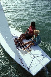 Father and son sailing a Lazer dinghy