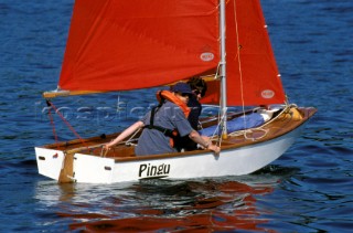 Couple relaxing in a wooden dinghy