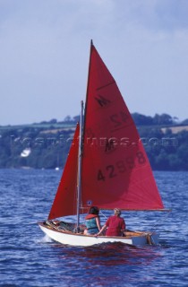 Two girls learning to sail a dinghy