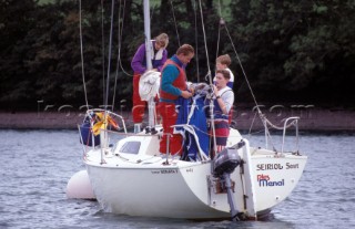 A family rigging their boat to go sailing