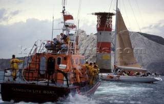 The Yarmouth Arun 52 RNLI lifboat standing by alongside the maxi Longobarda which is aground on Goose Rock next to the Needles lighthouse