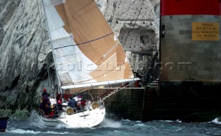Sailing yacht Spirit of the North is towed to safety after running aground during the Round the Island Race, Isle of Wight, UK