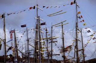Masts of tall ships and yachts dressed in colours