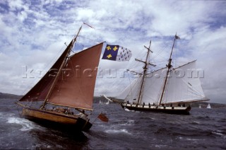 Classic sloop and tall ship schooner off the coast of Falmouth, UK