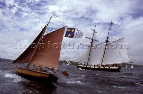 Classic sloop and tall ship schooner off the coast of Falmouth UK