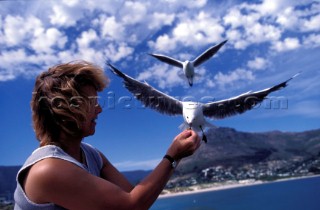 Woman feeding sea gull