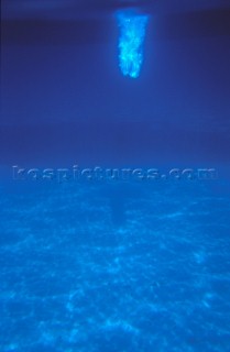 Underwater view of diver breaking surface
