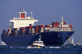 Laden container ship crossing busy shipping channel