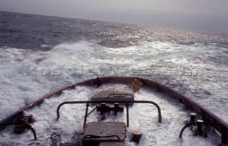 Stern of commercial tug boat ship in rough seas
