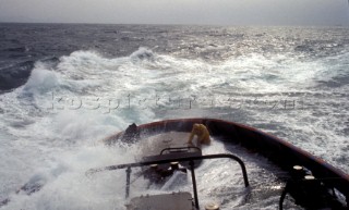 Stern of commercial tug boat ship in rough seas