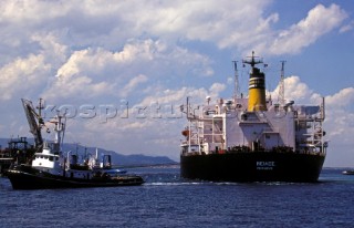 Commercial tug manoevres an oil tanker