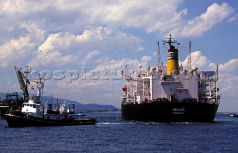 Commercial tug manoevres an oil tanker