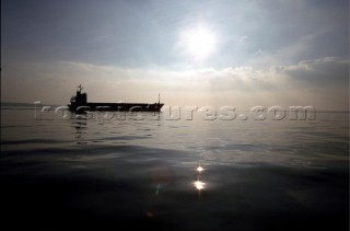 Silhouette of tanker on calm sea