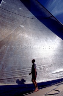 Crew member check the trim of huge headsail onboard Wally yacht Wally B