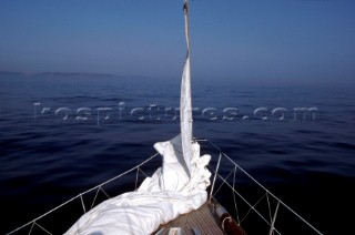 Prepared headsail ready to hoist on foredeck of Swan yacht
